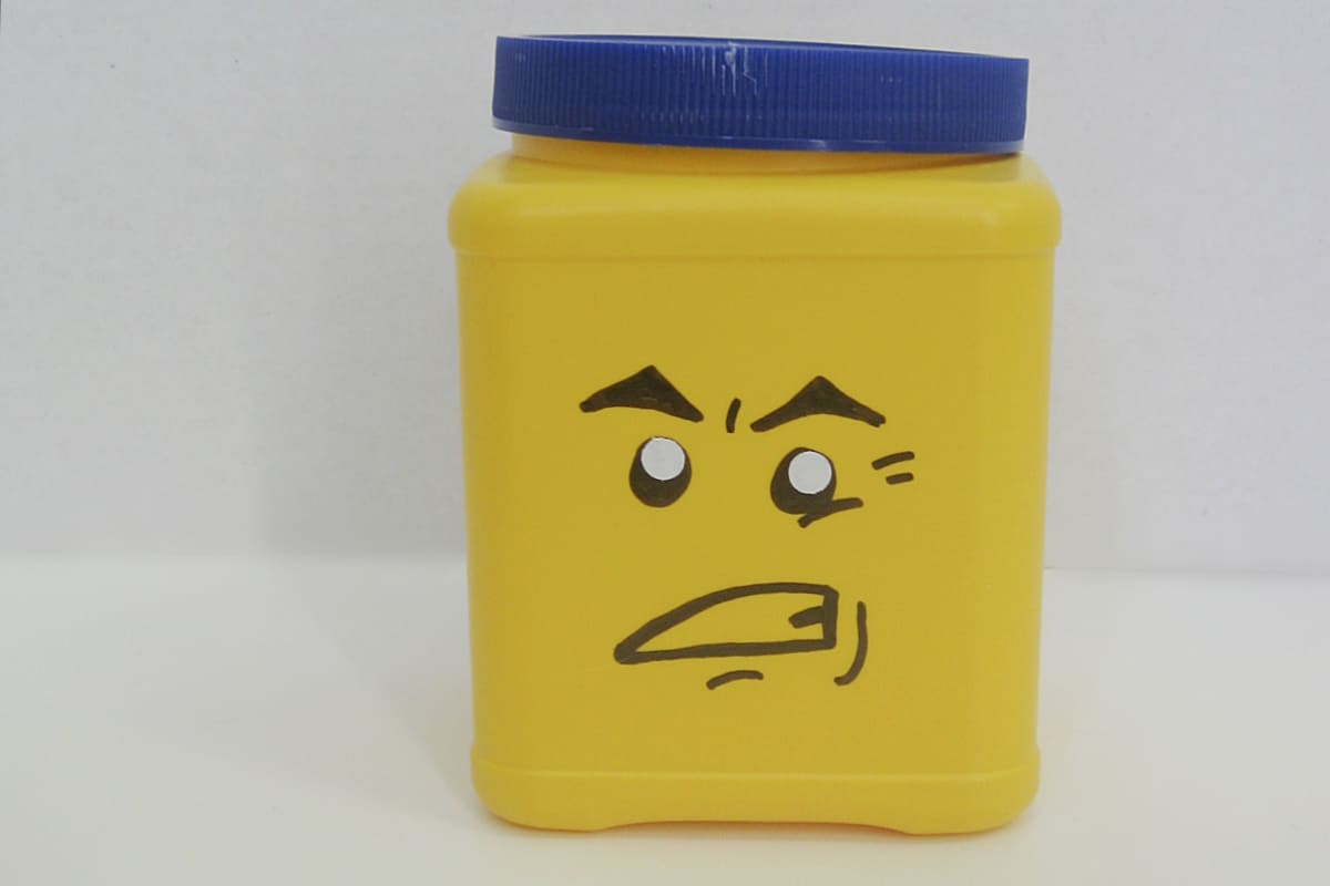 yellow can with blue lid and DIY Grrr LEGO face.