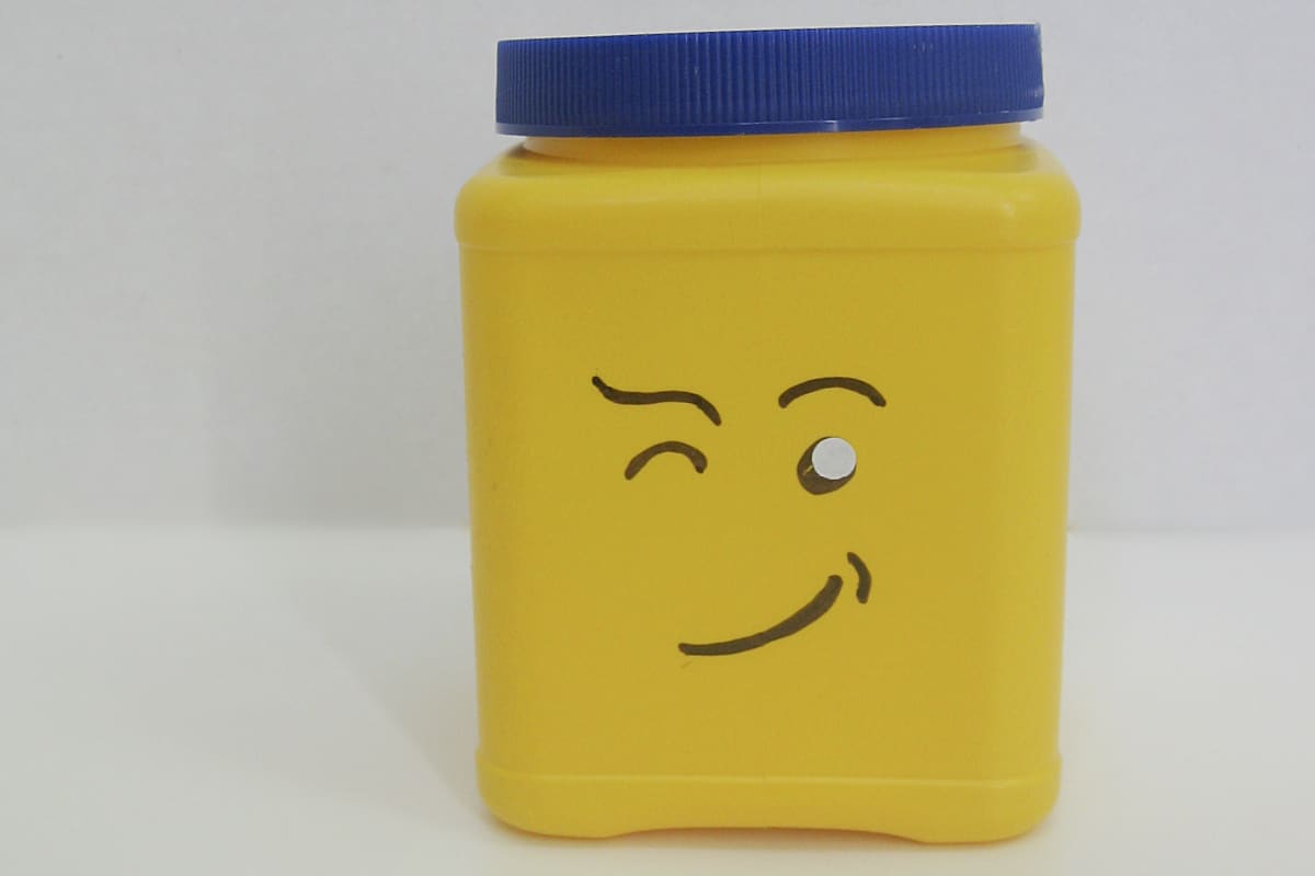 yellow can with blue lid and DIY winking LEGO face.