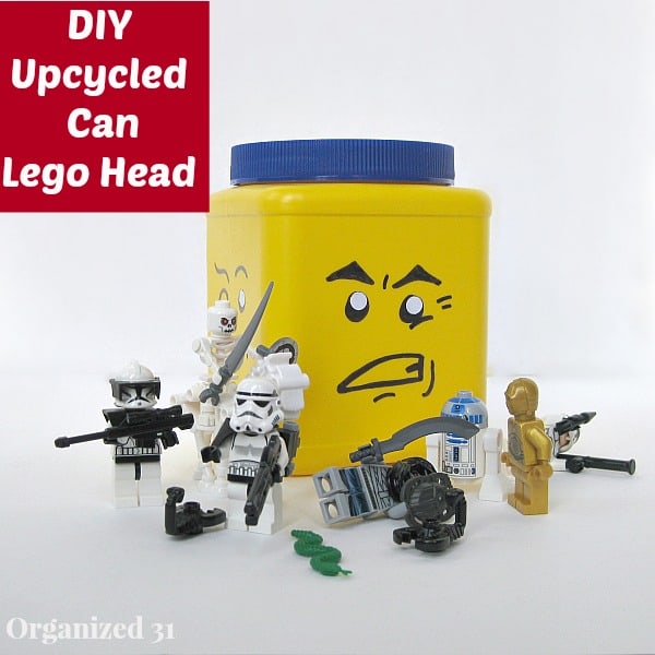 Yellow storage can with angry face and LEGO figures on table in front with title text reading DIY Upcycled Can Lego Head
