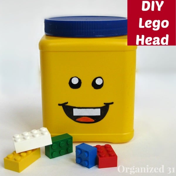 Yellow storage can with smiling face and LEGO blocks on table in front with title text reading DIY Lego Head