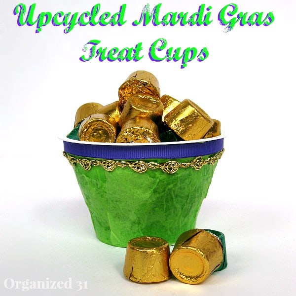 a green and gold decorated cup holding gold candy with title text reading Upcycled Mardi Gras Treat Cups
