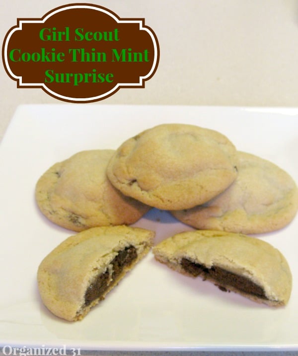 3 cookies stacked on white plate with one cookie broken open in front so you can see dark chocolate interior with title text reading Girl Scout Cookie Thin Mint Surprise