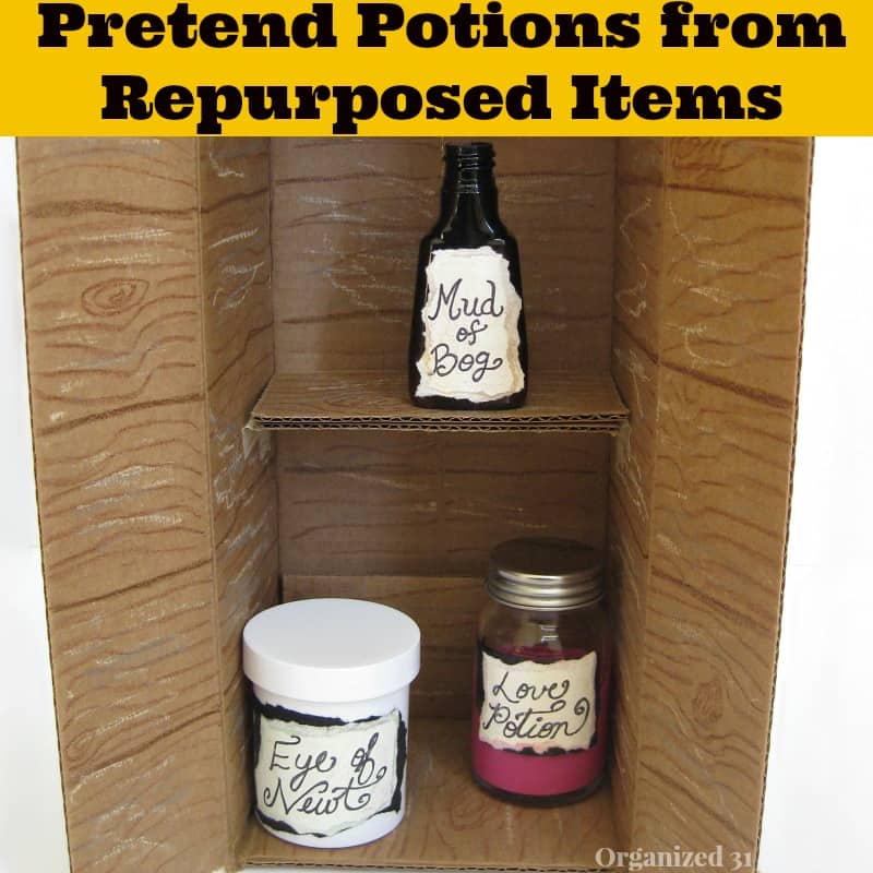 a cardboard box decorated to look like a cabinet with jars of magic potion inside with title text reading Pretend Potions from Repurposed Items 