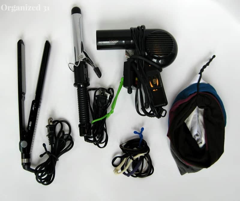 overhead view of hair appliances, hair ties and hair bands neatly organized with colorful ties