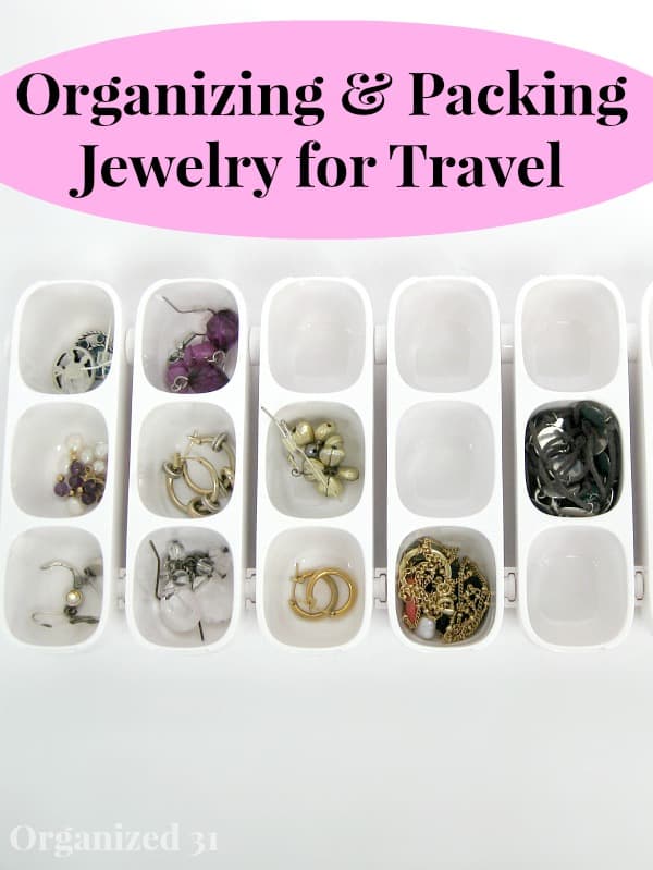 several white containers with jewelry in them with title text reading Organizing & Packing Jewelry for Travel