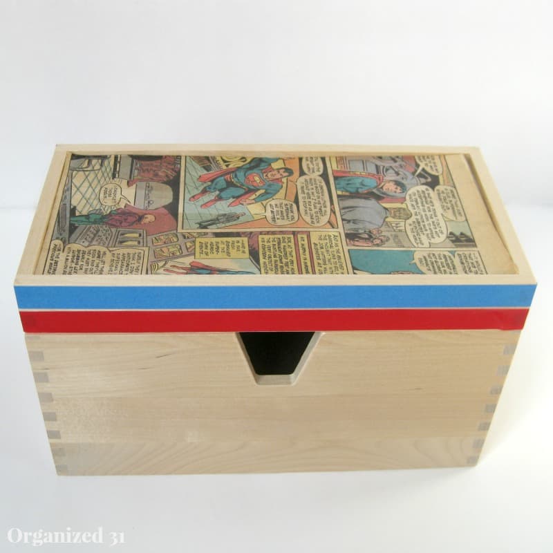 a wooden box with a comic book page on the lid