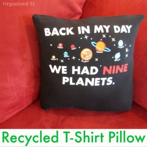 black pillow with planets on red chair