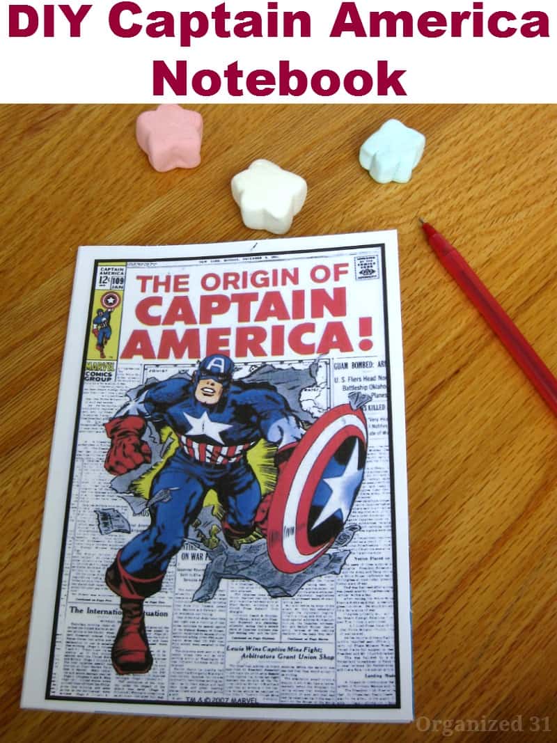 Captain American note book next to red pen on wood table