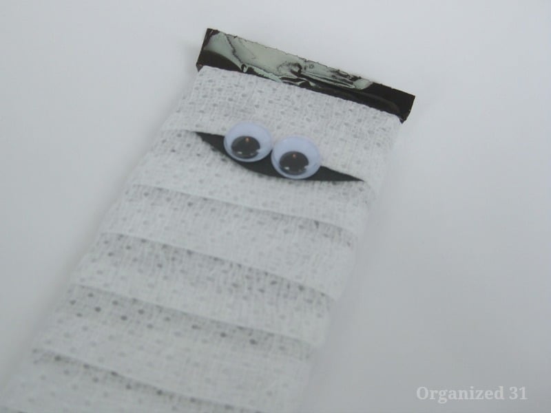 close up of googly eyes on gauze wrapped candy bar