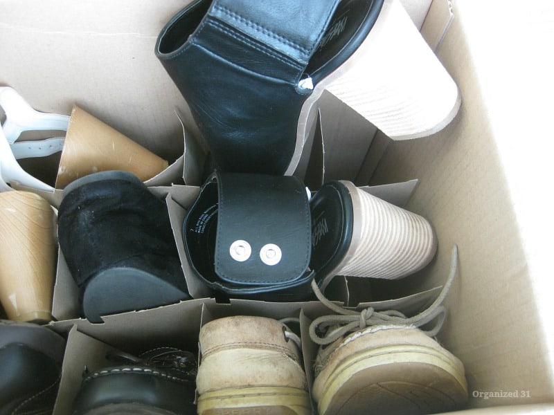 close up of shoes organized in box, showing high heel on one shoe.