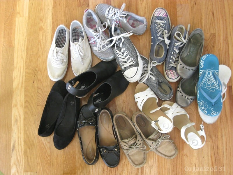 pile of shoes on wood floor.