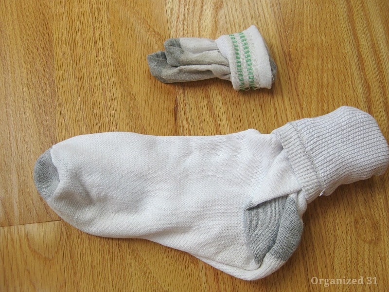 pair of child's socks and pair of adult socks with the top folded down.
