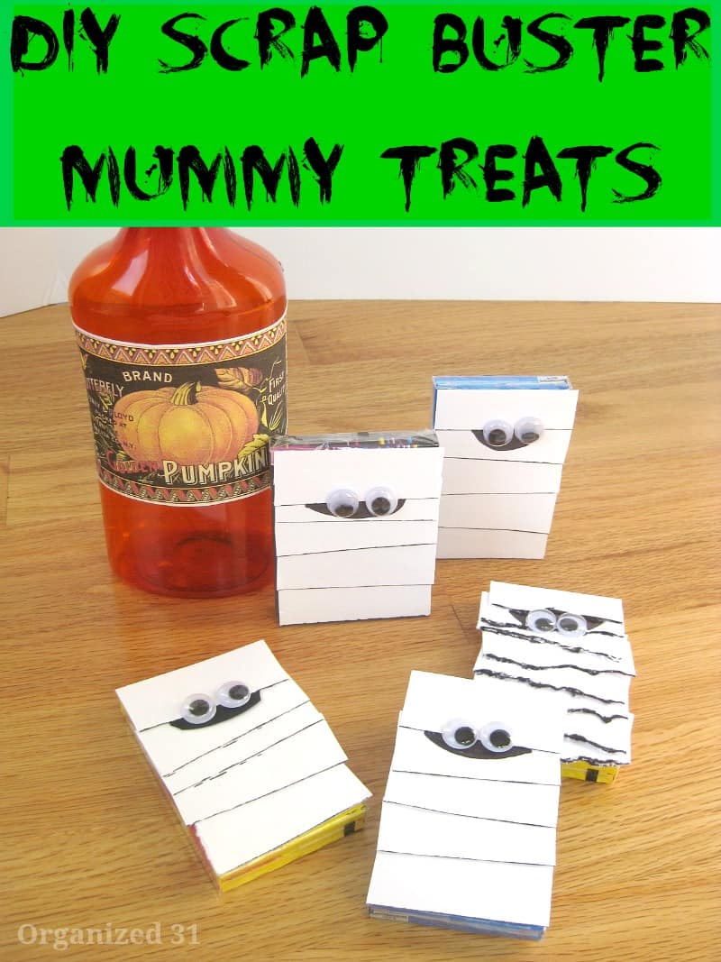 packs of gum decorated to look like mummies next to DIY pumpkin potion bottle.