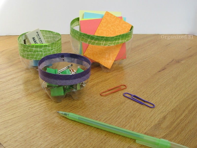 close up of office supplies in decorated clear bowls