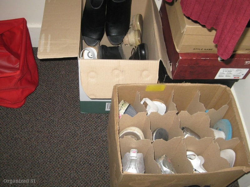 shoe boxes in closet with wine box filled with organized shoes.