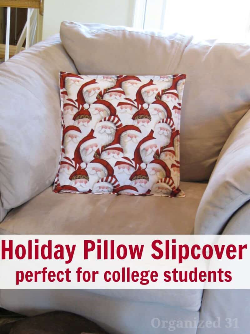 Pillow with Santa faces on cream chair