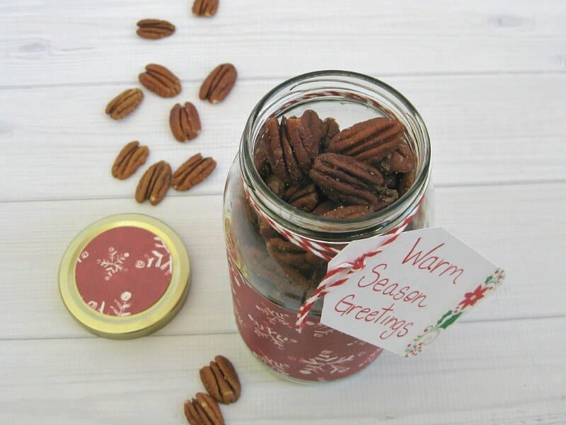 close up of open jar filled with spicy pecan with gift tag