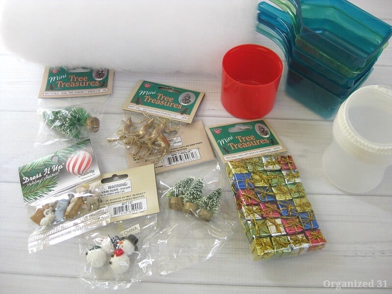 overhead view of plastic laundry scoops, packages of mini Christmas decorations and quilt batting