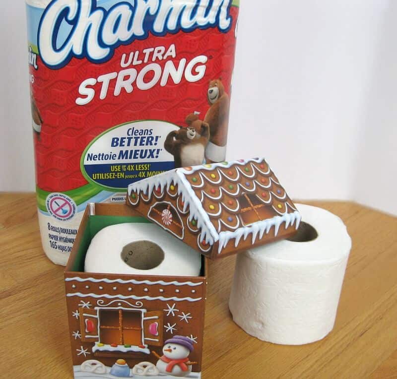 package of toilet paper, roll of toilet paper inside decorative box on wood table