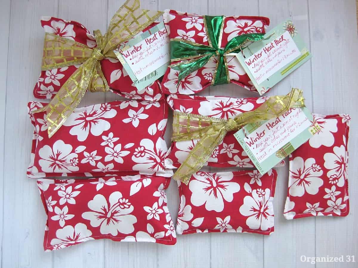 Red and white floral DIY rice heat packs tied with ribbons.