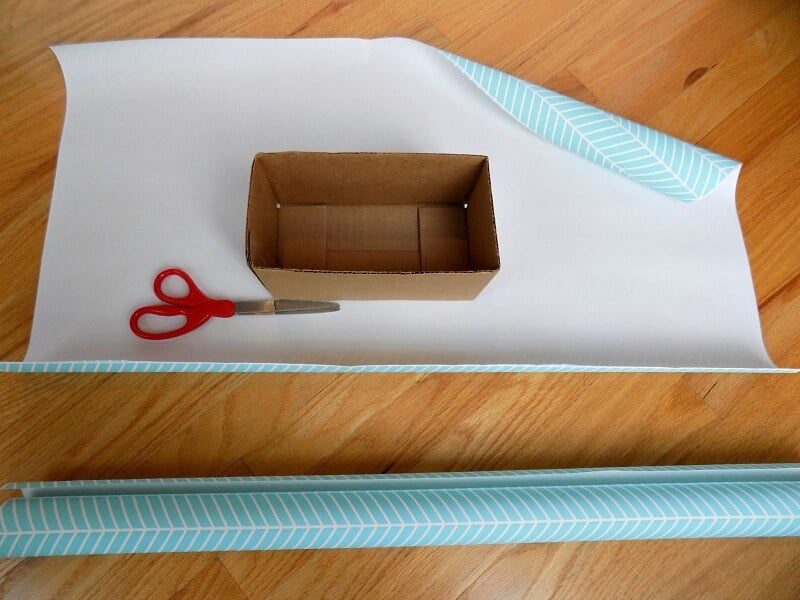 roll of blue and white wrapping paper cut to fit cardboard box