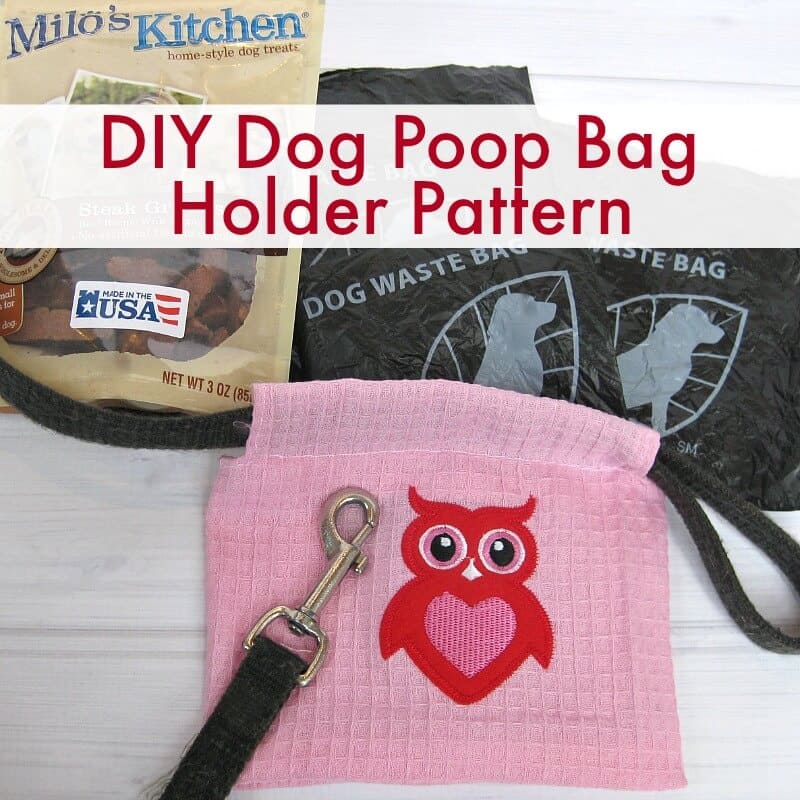 bag of dog treats, dog waste bags and pink dog poop bag holder on black leash