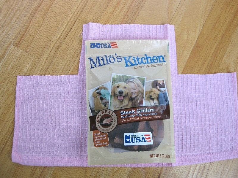 bag of dog treats laying on pink fabric