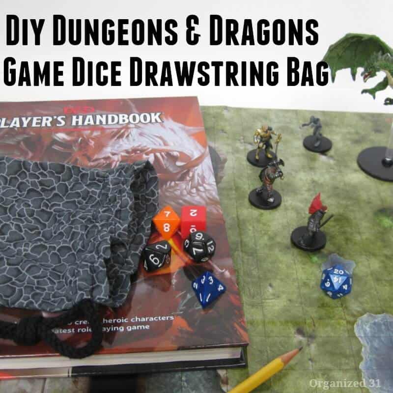 Dungeon and dragons dice near cloth bag on book and Dungeon and Dragons game board