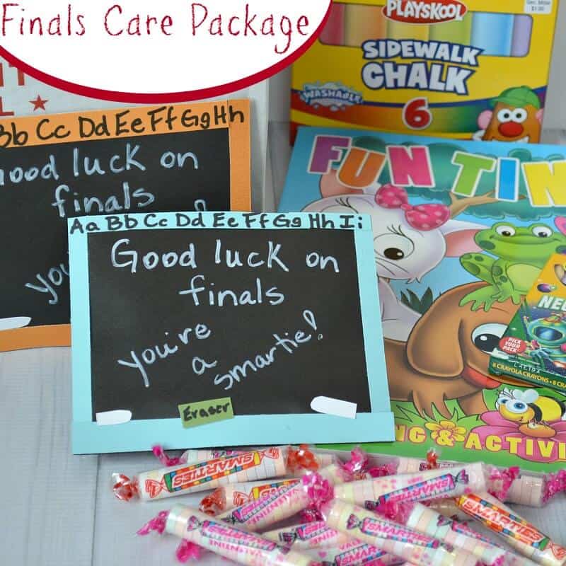 2 cards that look like chalkboards with note "good luck on finals, you're a smartie" next to box of sidewalk chalk,  brightly colored coloring books and Smarties candy