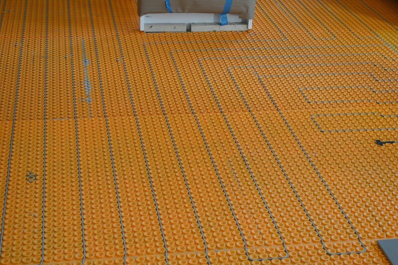 orange floor underlayment on floor showing pattern of circles