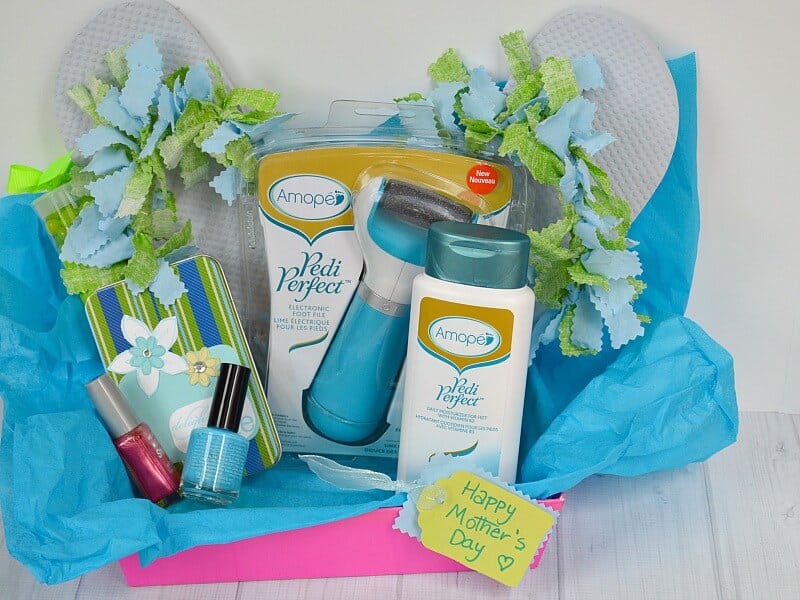 gift basket filled with blue and green gift items for foot care and yellow label that says Happy Mother's Day