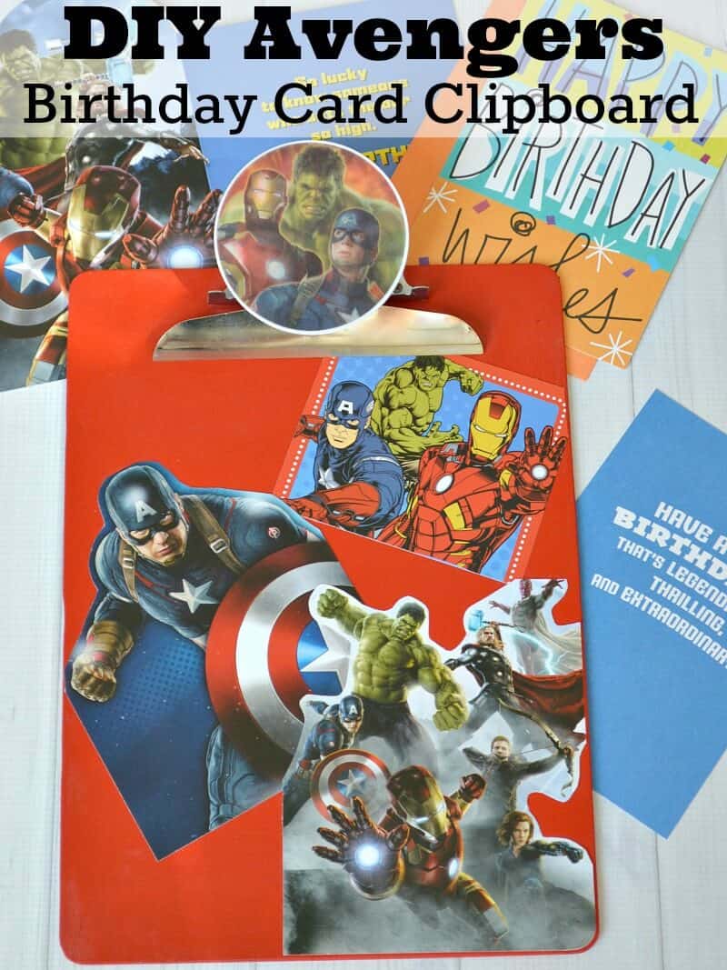 overhead view of red clipboard with superhero images and birthday cards scattered on table