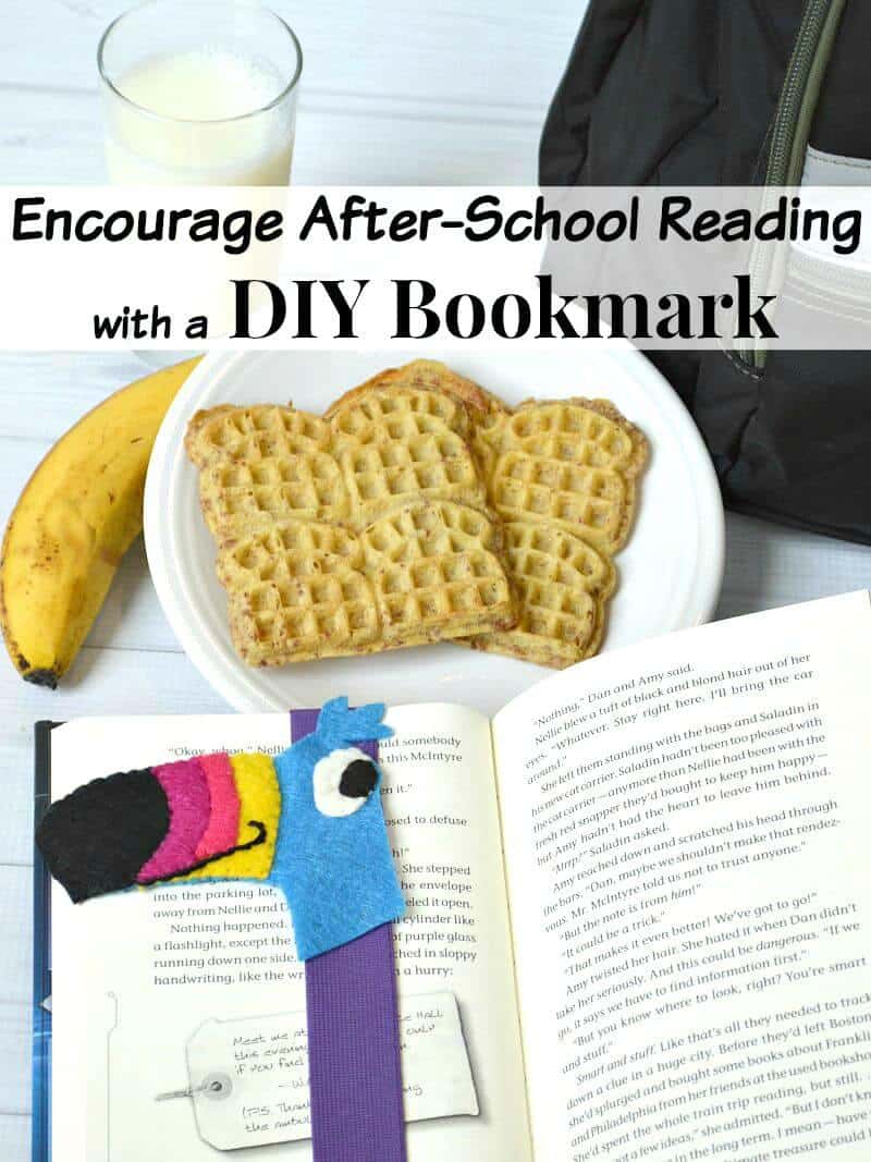 DIY felt book mark with toucan head on book next to plate of waffles, banana and glass of milk  and black lunchbox