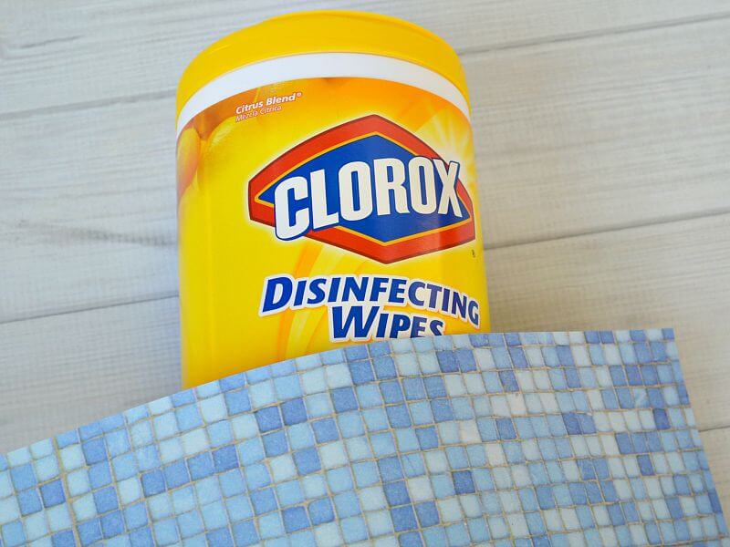 yellow Clorox wipes container with blue paper laying on top