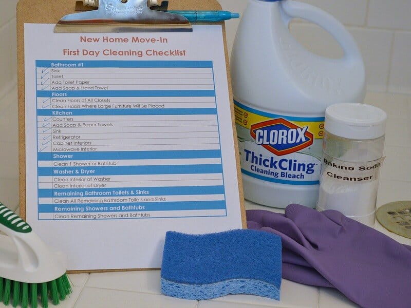 red and blue checklist next to cleaning supplies.