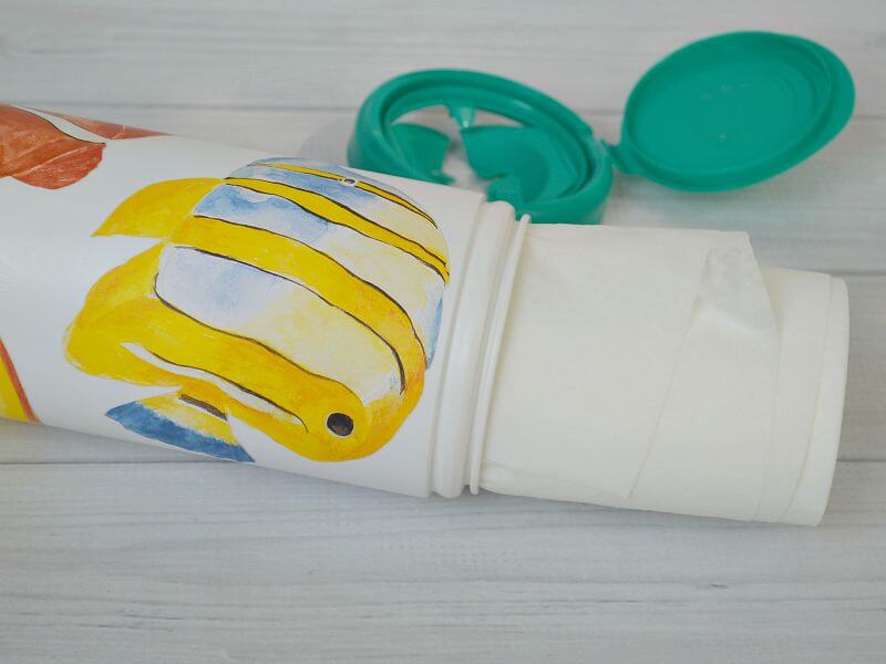 disinfecting wipes container with yellow fish on bottle with roll of wipes pulled halfway out of container