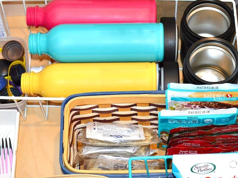 7 easy tips for an organized lunchbox drawer. It's back-to-school time and time to organize your kitchen. These tips are encourage your child's independence and are earth friendly.