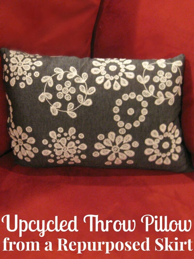 grey and white flower pillow on red chair