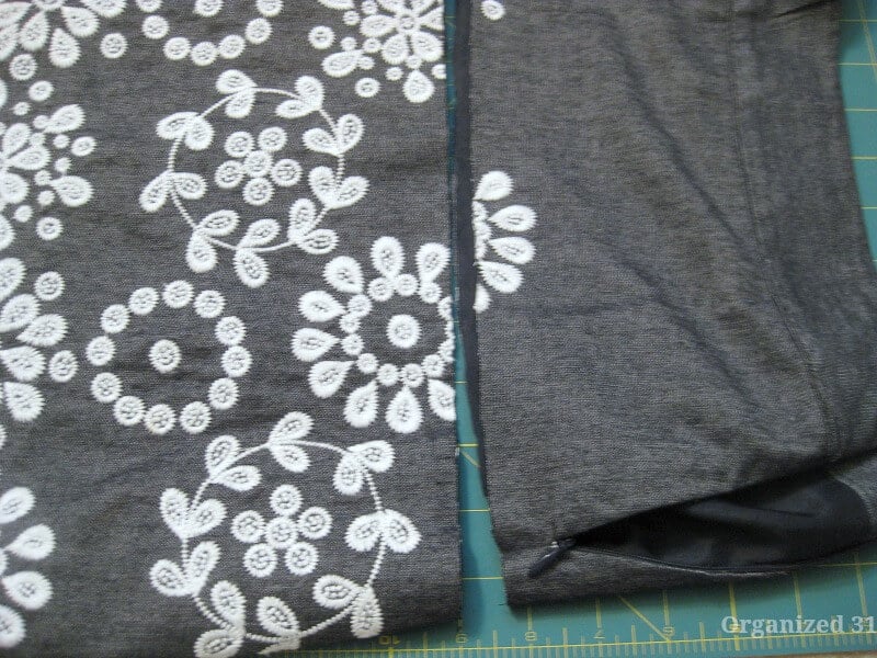 grey skirt with white flowers on green cutting board with portion cut off in straight cut