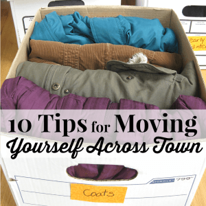 document box with coats neatly folded in it with title text overlay reading 10 Tips for Moving Yourself Across Town