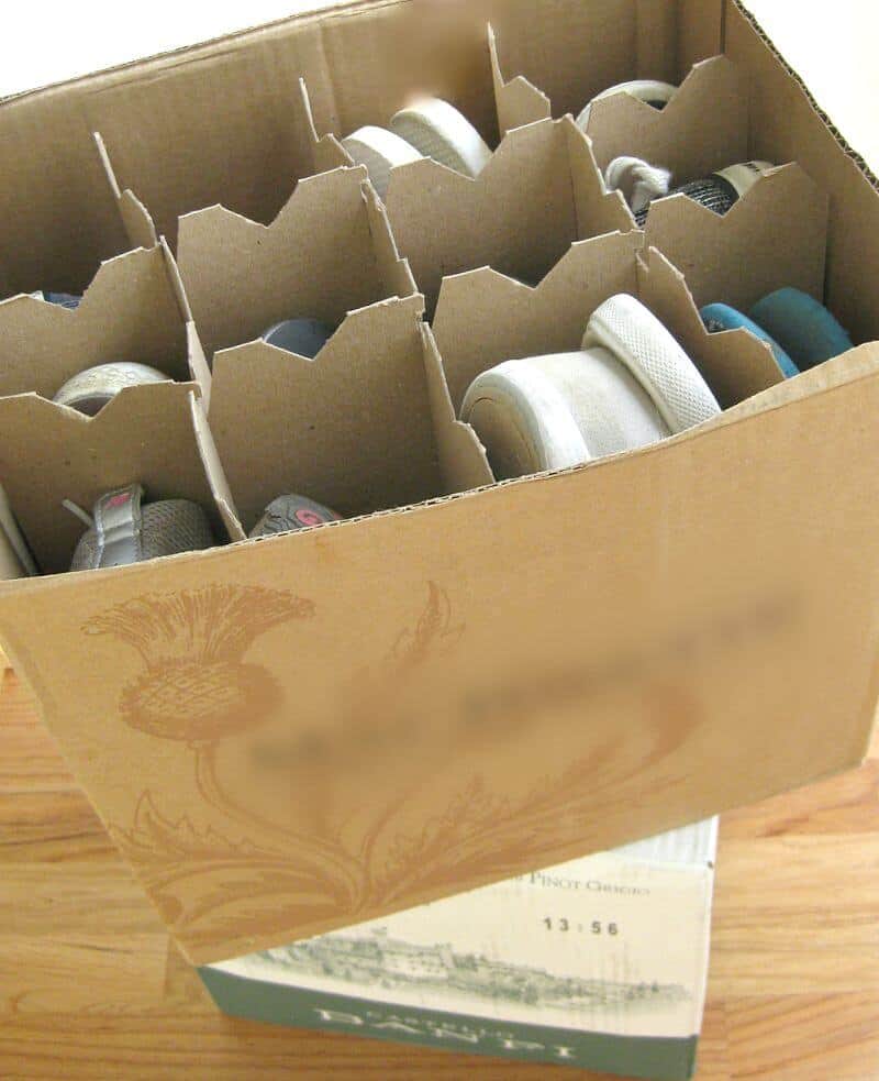 shoes packed into a cardboard wine box