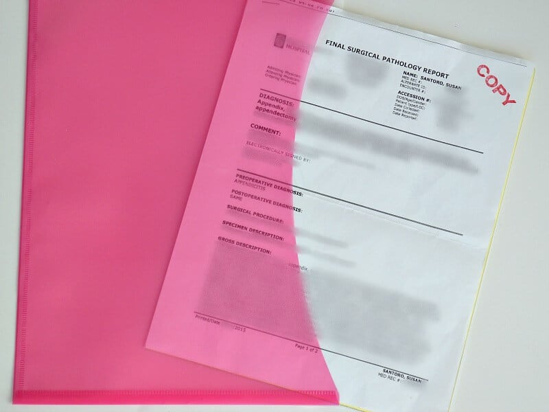 pink folder with stack of papers labeled final surgical pathology report