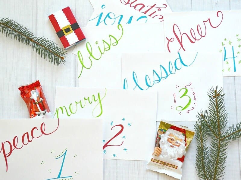 overhead view of Christmas advent envelopes with bright color words.