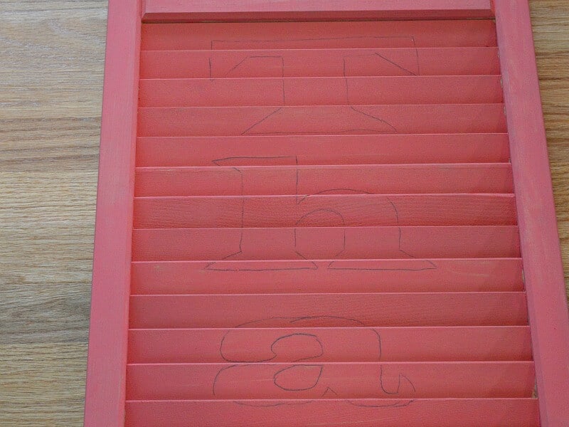 orange shutter with outline of letters