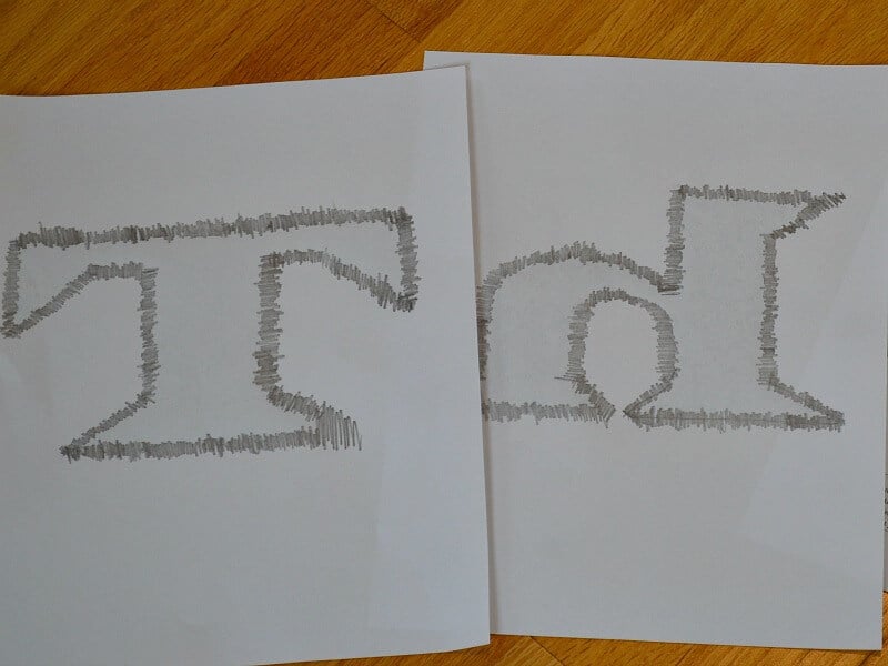 backside of printed letters with edges of letter scribbled on with pencil to outline