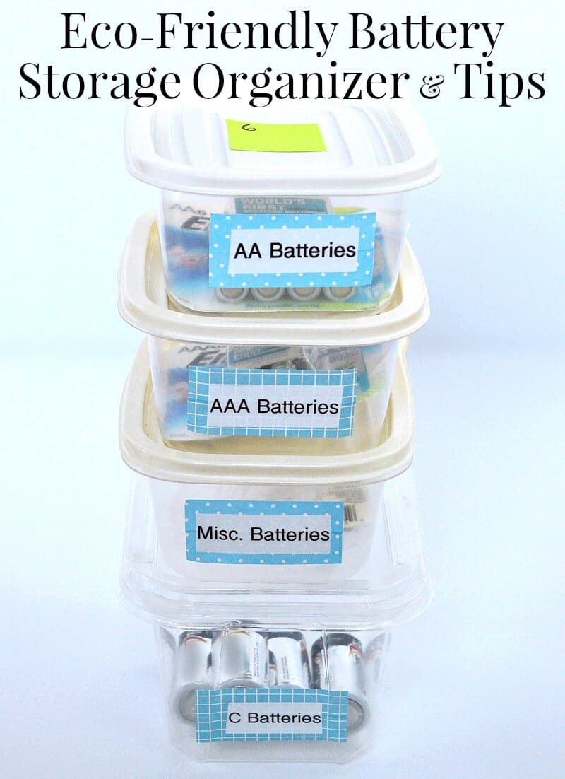 4 small clear containers stacked with blue and white labels with names of different sizes of batteries on white table