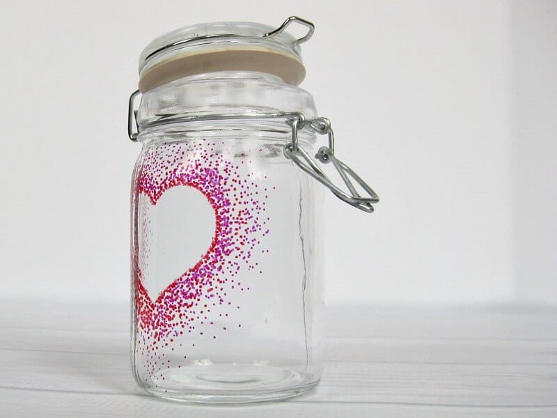 glass jar with dot heart image on white wood table