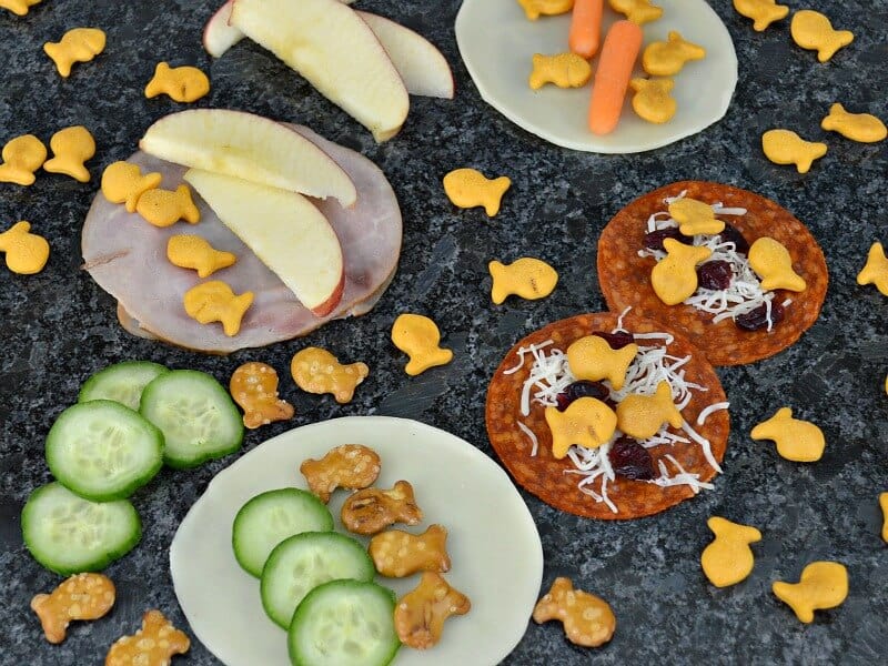 variety of snack tacos on black counter with ingredients scattered around