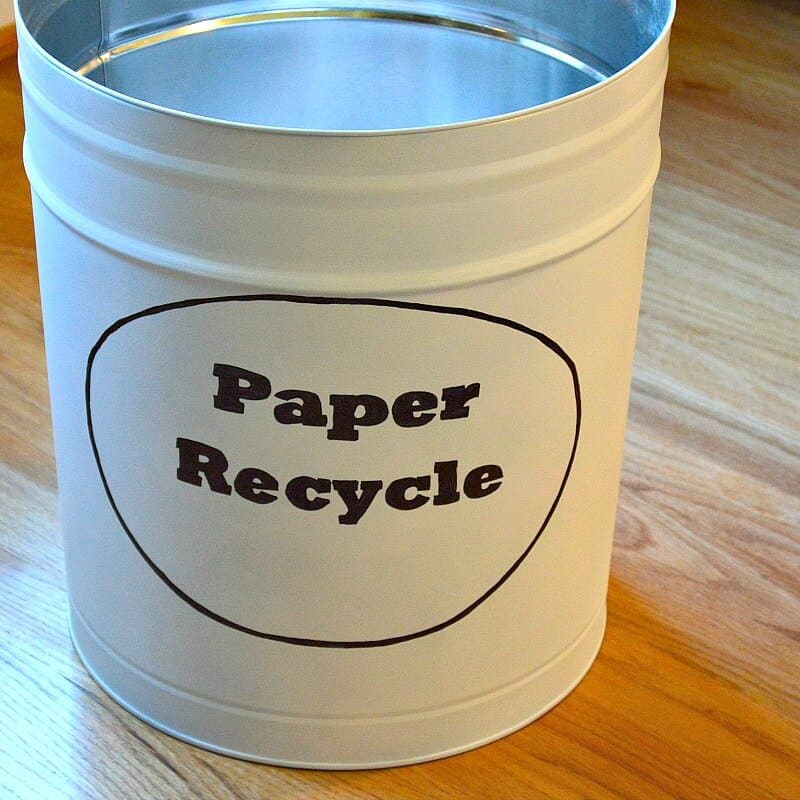 white can with black oval and text "paper recycle" on the front