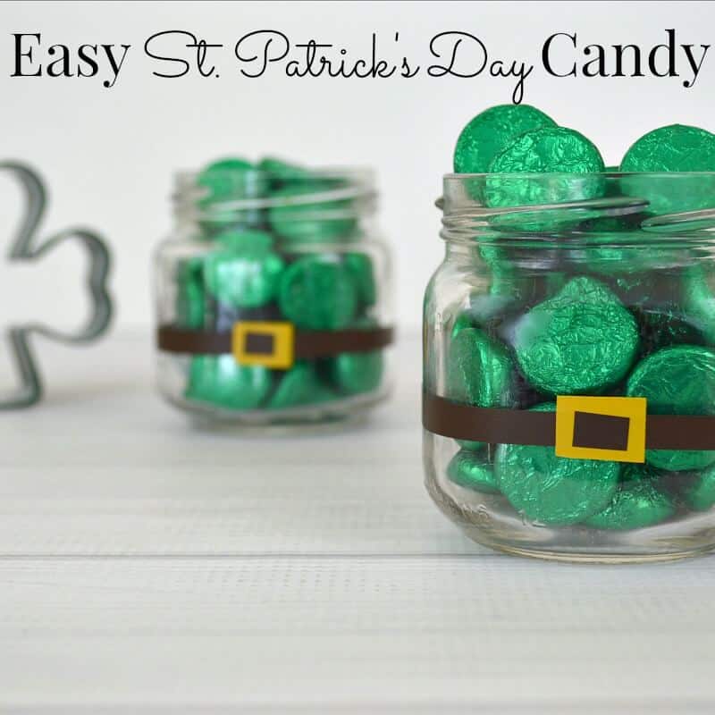 2 small glass jars with belt buckle added holding green candy.